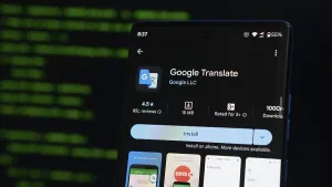 Digital Communication Tools Prints: Google Translate app displayed on a smartphone with a coding interface background