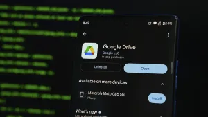 Mobile Phone Technology Prints: Smartphone displaying Google Drive app interface against a coding background
