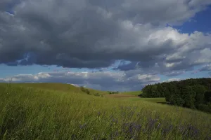 Cloudy Atmospheric Mood Prints: Dramatic cloud formations in the sky over a hillside in May