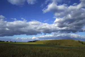 Cloudy Atmospheric Mood Prints: Dramatic cloud formations in the sky over a hillside in May