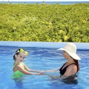 Woman In Swimsuit Prints: Daughter and mother in swimming pool tropical location background
