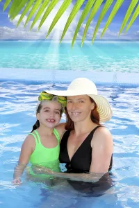 Woman In Swimsuit Prints: Mother and daughter hug in pool tropical beach Caribbean background