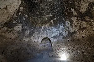 Deserted Sacral Building Prints: Cave system in the Takht-e Rostam stupa monastery complex