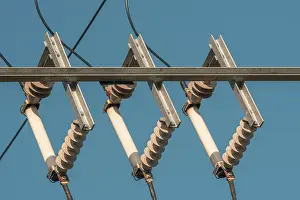 Power Industry Equipment Prints: Ceramic eletric insulators outside on the sky background