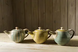 Pottery Making Process Prints: Ceramic workshop, three glazed pots on workbench