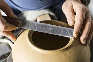 Traditional Crafts Bavaria Prints: Ceramic workshop, hands measuring diameter of opening with ruler