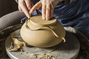 Handcrafted Ceramic Goods Prints: Ceramic workshop, hands shape bottom of pot on pottery wheel