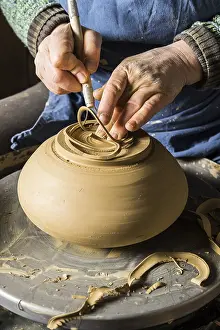 Handmade Ceramic Art Prints: Ceramic workshop, hands shape bottom of pot on pottery wheel