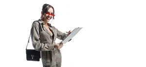 Business Concept Image Prints: Charming girl makes notes on the tablet
