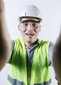 Male Construction Worker Prints: Cheerful builder engineer taking a selfie isolated