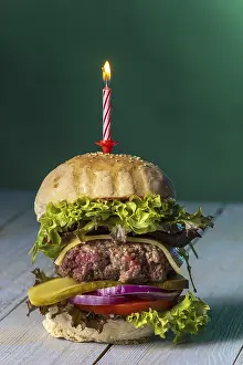 High Calorie Dishes Prints: Cheeseburger with a burning candle