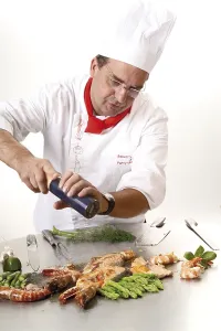 Food Photography Europe Prints: Chef adding pepper at a teppan grill