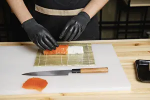 Raw Fish Recipes Prints: Chef puts salmon while preparing rolls
