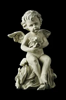 Archeological Site In Turkey Prints: Cherub with dramatic side lighting on a black background