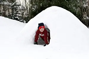 Happy Children Playing Outside Prints: Child plays in igloo