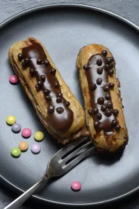 Unhealthy Sweets Prints: Two chocolate eclairs on a plate