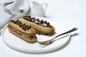 Chocolate Eclairs Prints: Two chocolate eclairs on a plate