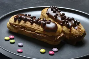 Unhealthy Sweets Prints: Two chocolate eclairs on a plate