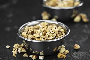 Close Up Hazelnuts Prints: Chopped Hazelnuts on rustic background as close up shot (selective focus)