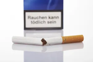 Smoking Ban Prints: Cigarette broken in half, cigarette pack in background