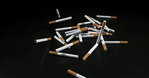 Addictive Drug Health Risks Prints: Cigarettes Falling against Black Background