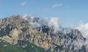Mountain Pass Scenery Prints: Cliffs and rocks in front of clouds