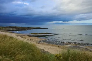 Atmospheric Coastal Scene Prints: Cliffs and sandy beach on coast under dramatic sky