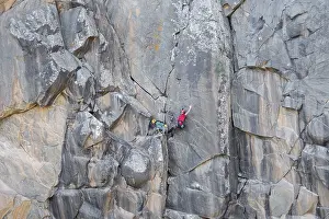Traditional Rock Climbing Prints: Climbers scale a rugged cliff using traditional techniques