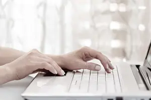 Modern Architecture Concept Prints: Close up of female hands using modern computer