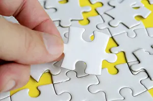Close Up Jigsaw Puzzle Prints: Close up of hand place missing jigsaw puzzle representing problem solving skill