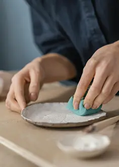 Motion Blur Photography Prints: Close up hand using blue sponge