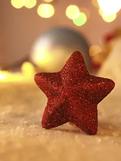 Deserted Snow Scene Prints: Close up of a red star shape in snow
