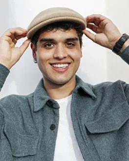 Close Up Man Prints: Close up smiley man posing with hat
