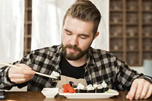 Asian Cuisine Meal Ideas Prints: Close up of sushi rolls on a table in a restaurant