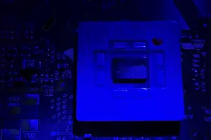 Electronic Circuit Board Prints: Close-up of blue lighted microchip on electronic computer circuit board