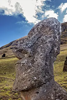 Pacific Ocean Rock Formations Prints: Close-up of a Moai statue with dramatic cloudscape in the background