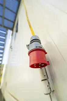 Black Forest Architecture Prints: Close-up of a red socket on the outside wall of a container building