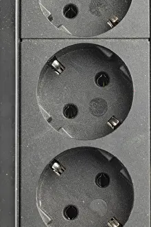 Energy Supply Systems Prints: Close-up of sockets in a black socket strip