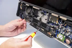 Quality Control Check Prints: Close-up of an unrecognizable technician fixing computer circuit board of a computer in a workshop
