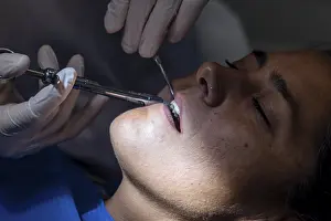 Female Dentist At Work Prints: Close up view of a teeth cleaning
