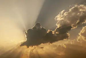 Deserted Landscape France Prints: Cloud in front of the sun showing rays of light