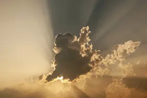 Cloudy Sky Europe Prints: Cloud in front of the sun showing rays of light