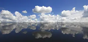 Deserted Coastal Area Germany Prints: Clouds in the blue sky reflected in the water
