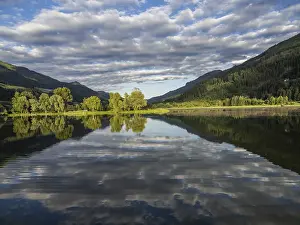 Cloudy Evening Atmosphere Prints: Clouds are reflected in the lake