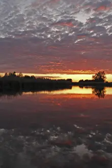 Northern Germany Nature Reserve Scenery Prints: Clouds in the sunset with reflection on the river Trebel