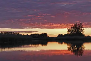 Northern Germany Nature Reserve Scenery Prints: Clouds in the sunset with reflection on the river Trebel