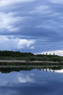 Northern German Nature Scenery Prints: Cloudy sky over a quiet river with trees in the background