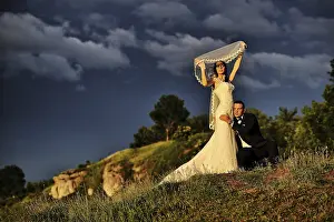 Bride And Groom Kiss Prints: Cloudy sky and wedding couple