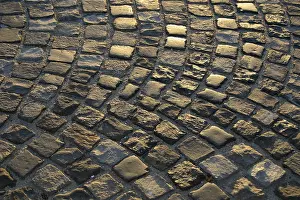 Evening Atmosphere Pictures Prints: Cobblestone road the setting sun