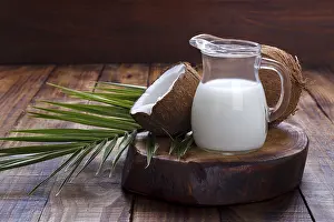 Healthy Food Concept Prints: Coconut shell and milk on brown rustic background